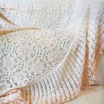 Delicata coperta color latte con motivi multicolori