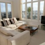 Divano beige per ampio soggiorno con terrazza aperta