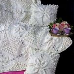 Fiori e coni sono l'ornamento principale di una coperta color latte