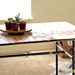 Tavolo realizzato in assi con struttura in tubi metallici