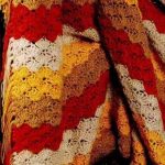 Una vivace combinazione di strisce in quattro colori per una coperta accogliente