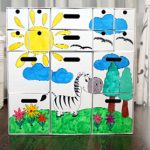 Cassettiera bianca in cartone con disegni di bambini