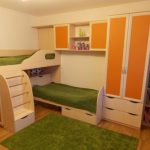 Un letto a castello con armadio a muro e ripiani è una buona soluzione per i bambini in età scolare