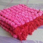 Copertina per neonati realizzata con pompon Aster
