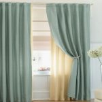 Tulle beige sulla finestra con tenda color menta