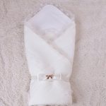 Bellissimo tappeto-coperta bianco con fiocco su elastico